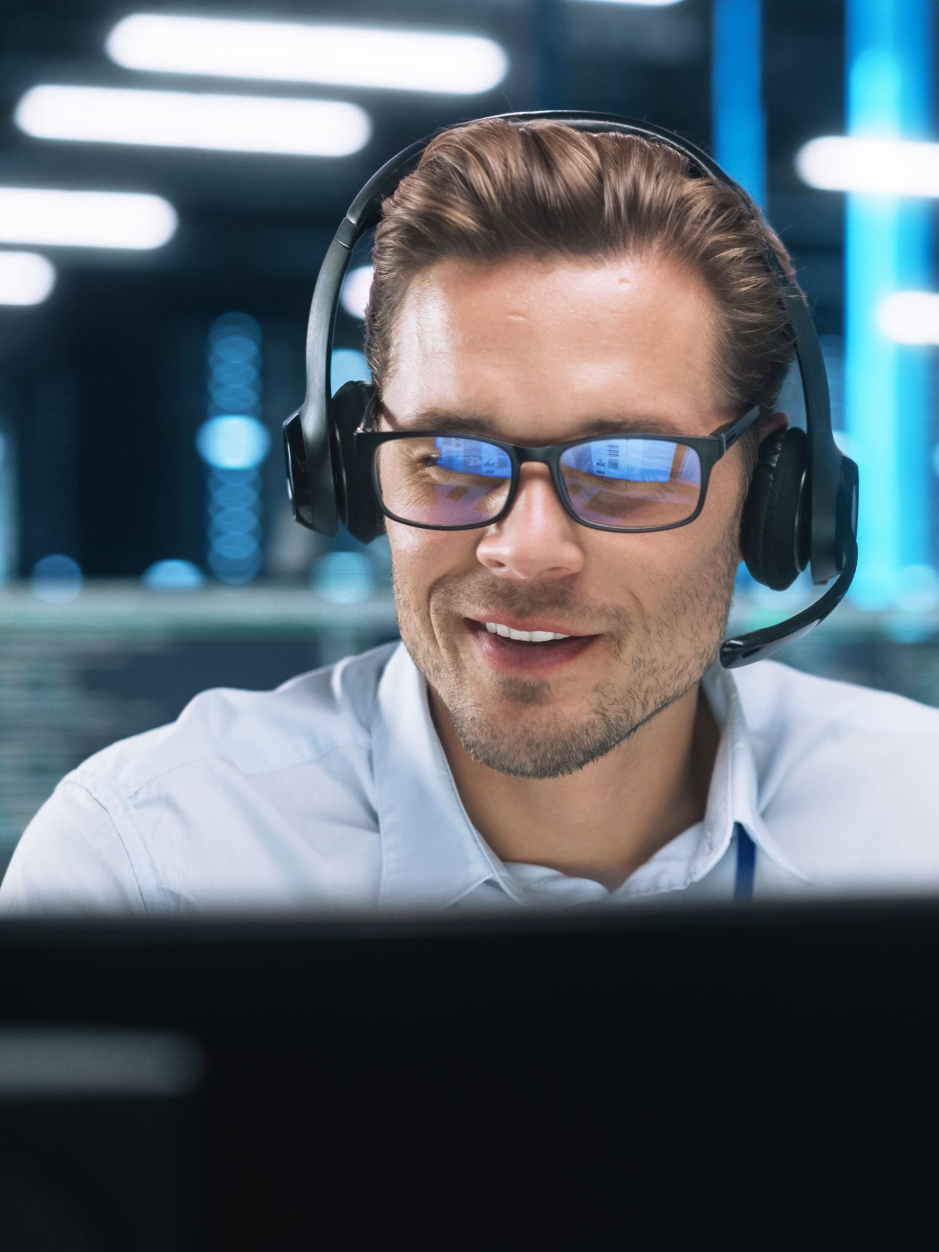 young man with Headset, Successful Manager of Call Center Sits in Office, Uses Computer, Talking on Video Conference with Client or Employee. Helpline Concept