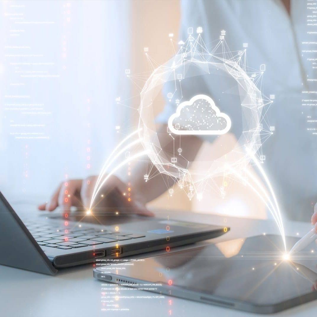 Woman uploading and transferring data from computer and tablet